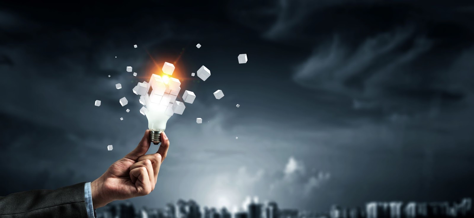 Abstract picture with a hand holding a lightbulb