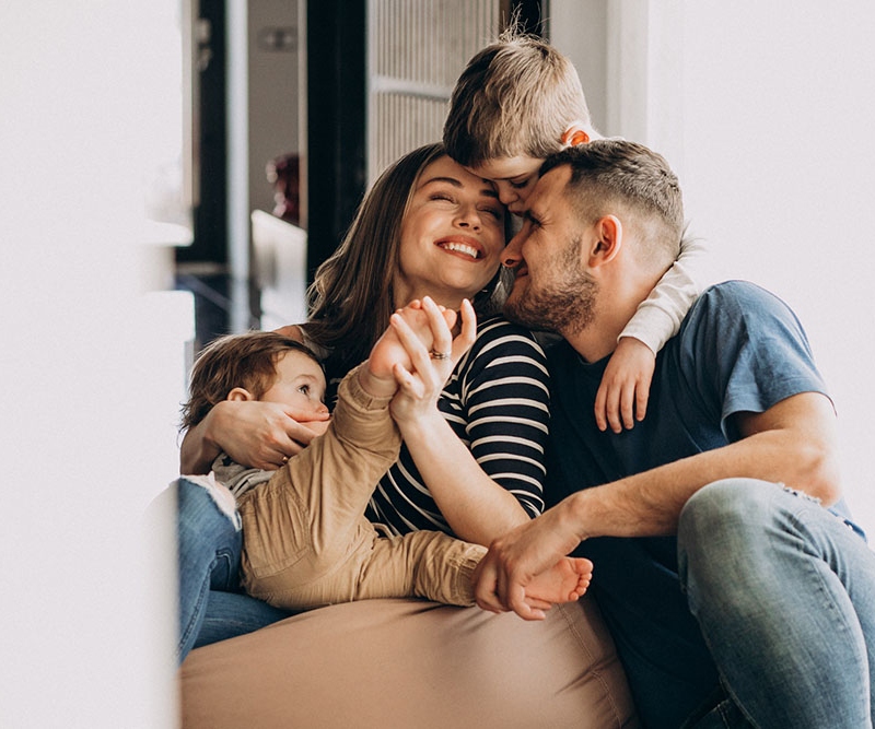 Young family with their sons at home having fun